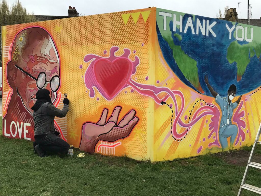 Tommy Watkins works on Thank You NHS mural