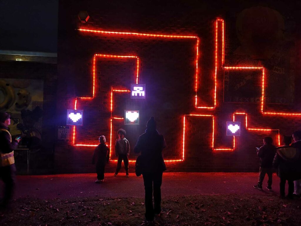 People interact with the responsive LED artwork