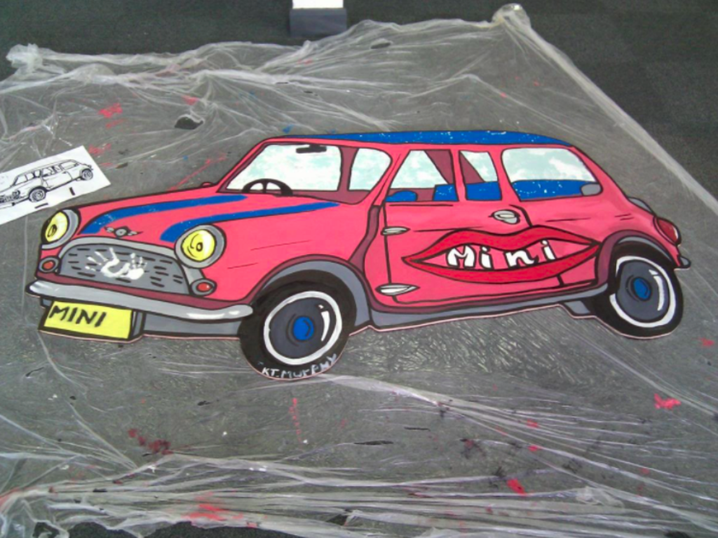 Painted pink Mini on mural.